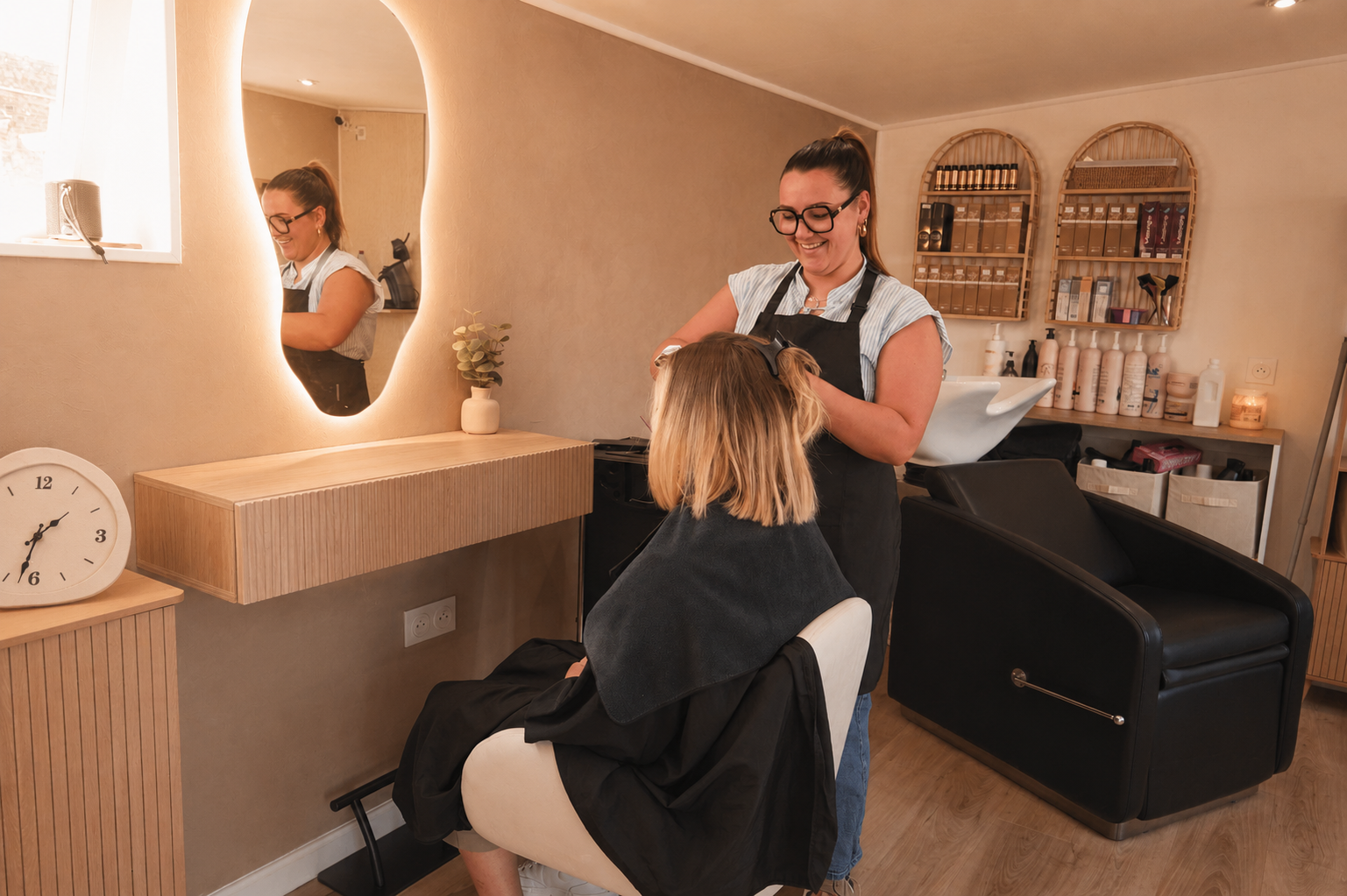 Elegant salon interior featuring a stylish setup with a ring light and mirror.